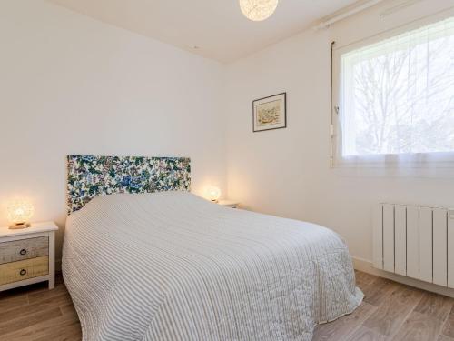 une chambre blanche avec un lit et une fenêtre dans l'établissement Apartment Domaine des roches by Interhome, à Trouville-sur-Mer