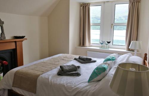 a bedroom with a bed with two towels on it at School House in Dunan