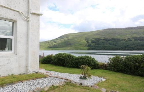 a house with a view of a body of water at School House in Dunan