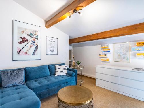un salon avec un canapé bleu et une table dans l'établissement Apartment Le Clos Sainte Anne-1 by Interhome, à Saint-Tropez