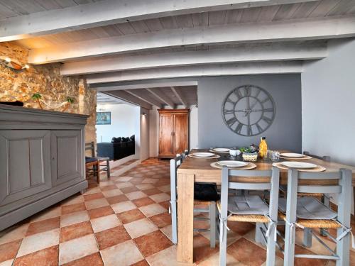 a dining room with a wooden table and chairs at Holiday Home Les Oyats by Interhome in Dolus d'Oléron