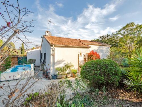 a cottage with a swimming pool in a garden at Villa Liou Miou Souleou by Interhome in Mouans-Sartoux