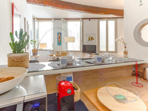 a kitchen with a counter top with a red appliance at Apartment Le Mascoïnat by Interhome in Nice