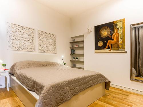 a bedroom with a bed and a painting on the wall at Apartment Le Mascoïnat by Interhome in Nice