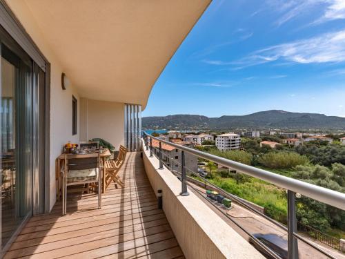 d'un balcon avec une table et une vue sur la ville. dans l'établissement Apartment Le Neptune by Interhome, à Porto-Vecchio