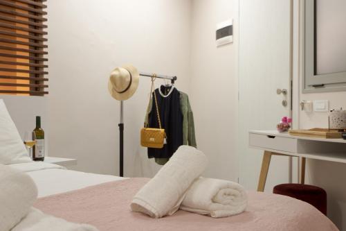 a bedroom with a bed with a towel on a table at Mitos mini suites in Chania Town