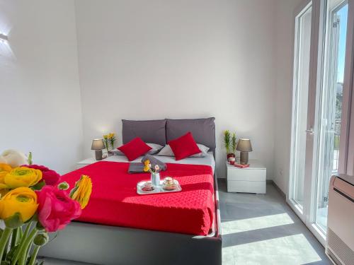 a bedroom with a red bed with a red blanket at Holiday Home Casa Luca by Interhome in Imperia