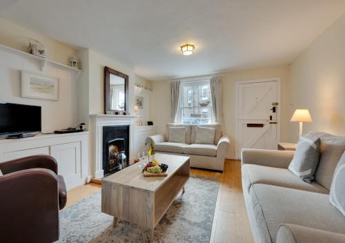 a living room with a couch and a coffee table at Shrimpers in Southwold