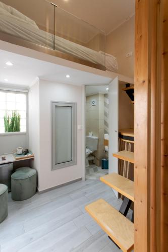 a room with a bathroom with a sink and a mirror at Mitos Cozy Rooms in Chania