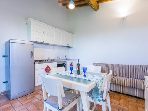 a kitchen with a table and chairs and a refrigerator at Apartment Lavender by Interhome in Santa Luce