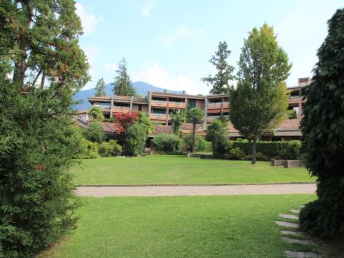 a building with a park in front of it at Holiday Home Villa Camelia by Interhome in Porto Valtravaglia