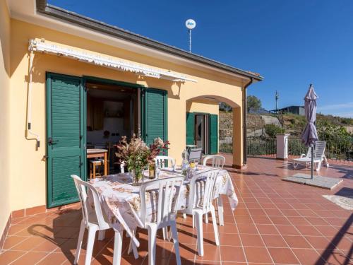 a table and chairs on the patio of a house at Apartment Aurora by Interhome in Costarainera