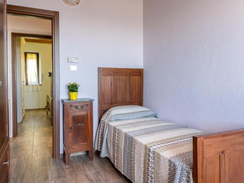 a bedroom with a bed and a dresser next to a door at Holiday Home Asia by Interhome in Scansano