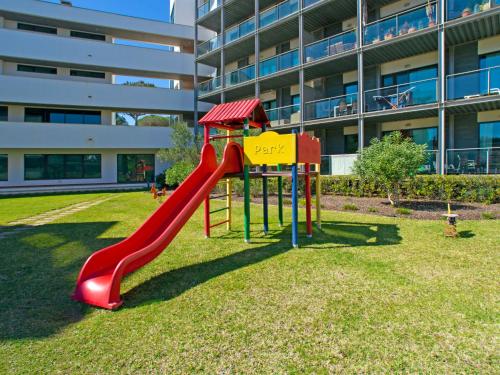 a playground with a slide in front of a building at Apartment Sunna Residence by Interhome in Vilamoura