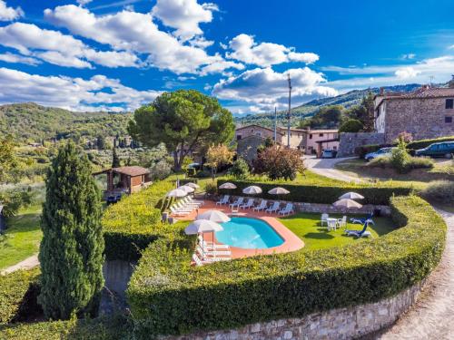 an estate with a swimming pool and umbrellas at Apartment Colombaia - Aia by Interhome in Lucolena in Chianti