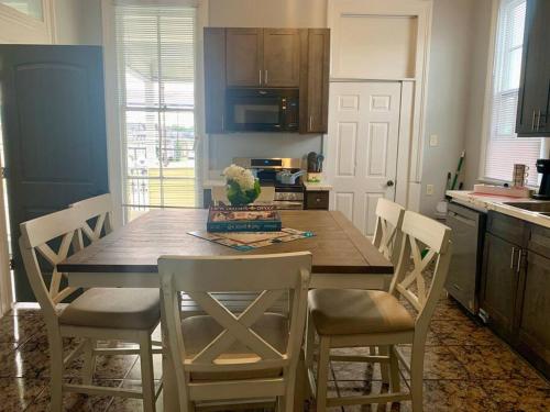 a kitchen with a wooden table and chairs at The Balcony on St Ann in New Orleans