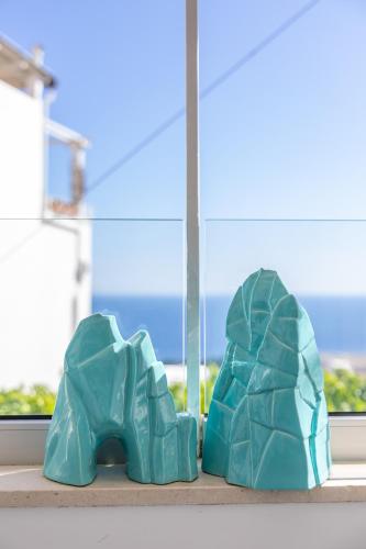 a pair of blue shoes sitting on a window sill at Suite Belvedere Capri Exclusive Rooms in Capri