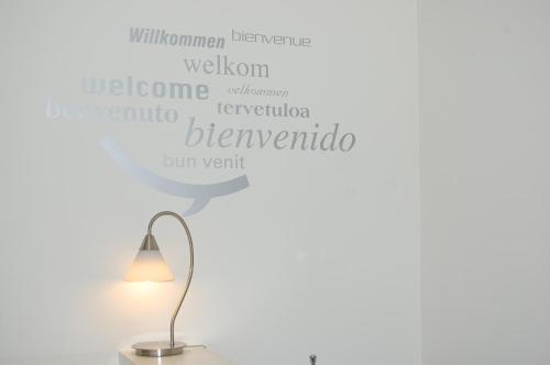 a lamp with a word list of different countries at Hostal Cabo Mayor in Santander