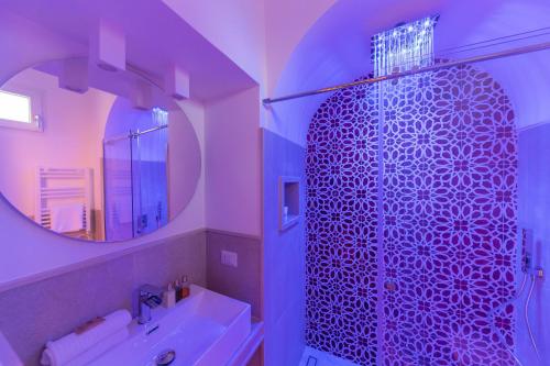 y baño con ducha, lavabo y espejo. en Suite Belvedere Capri Exclusive Rooms, en Capri