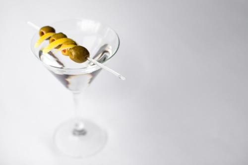 a martini glass with olives and a spoon at Holiday Inn Montreal Longueuil by IHG in Longueuil