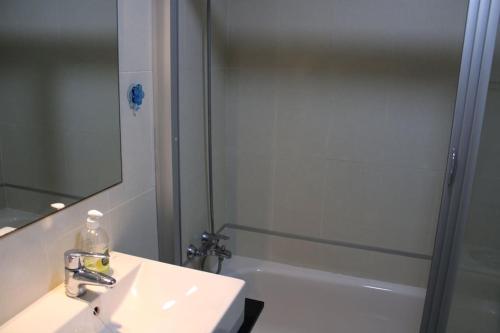 a bathroom with a sink and a shower and a mirror at 2 Bedroom Apartment Palma Verde in Cuevas del Almanzora