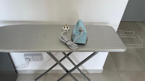 a table with a blue phone on top of it at Sandakan Homestay 3BedRoom 2Bath Joyful Cottage 喜悦小屋 For 5 guests in Sandakan