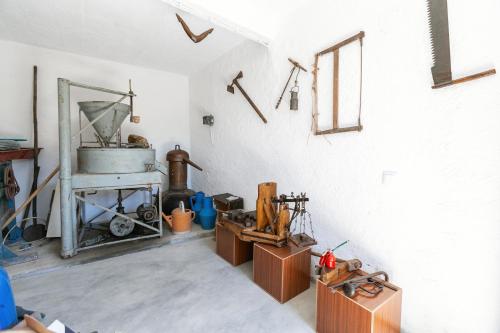 a room with a kitchen with a stove in it at Maria da Vinha - Country House in Góis