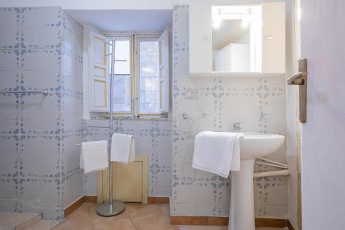 a bathroom with a sink and a mirror at Piazza Pretoria & Quattro Canti Roomy Flats with Balconies in Palermo