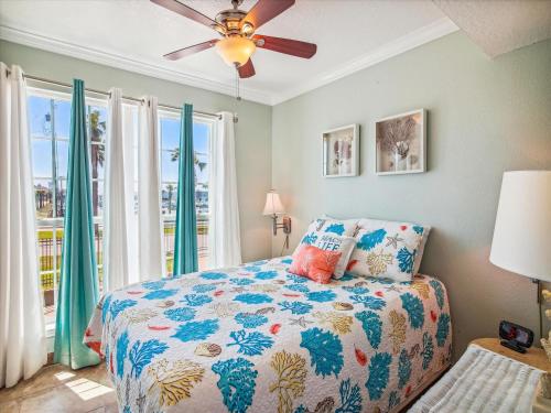 a bedroom with a bed and a ceiling fan at Victorian 8104-Gulf Dreams in Galveston