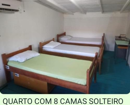 Un ou plusieurs lits dans un hébergement de l'établissement Hostel Floripa Lake House Lagoa Conceiçao 24HORAS
