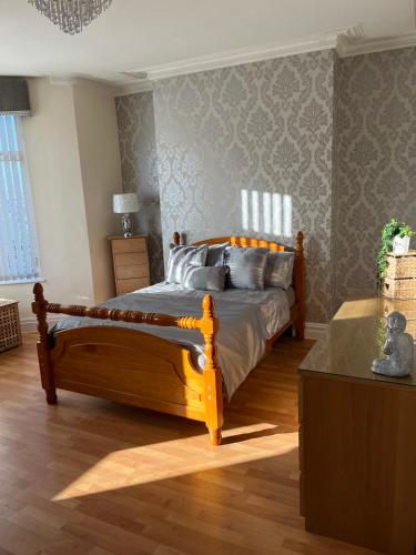 a bedroom with a wooden bed in a room at House in Anfield in Liverpool