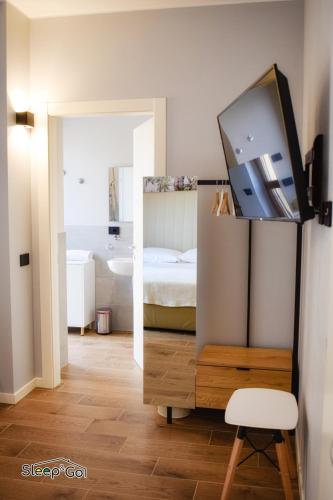 a bedroom with a bed and a tv and a mirror at GuerriniBNB Civico 5 in Manerbio