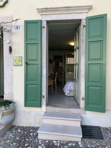 a door to a house with green shutters at Agriturismo Maso Giomo in Brentonico