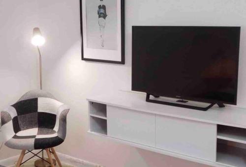 a living room with a television and a chair at LOCATION! Apartment in Coconut Grove with parking in Miami