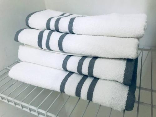 a stack of towels sitting on a shelf at LOCATION! Apartment in Coconut Grove with parking in Miami