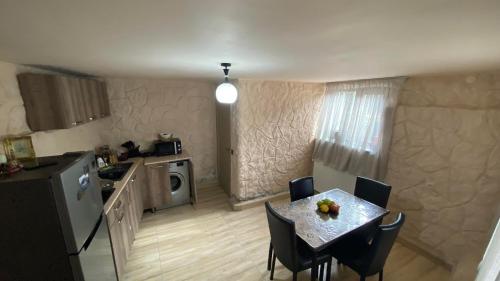 a small kitchen with a table and chairs in a kitchen at Four Season In Kazbegi in Stepantsminda