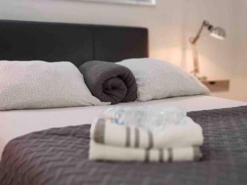 a bed with two towels on top of it at LOCATION! Apartment in Coconut Grove with parking in Miami