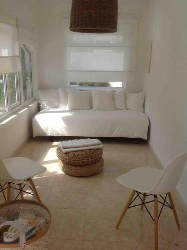 a living room with a white couch and two chairs at Private beautiful house - ( nice swimming Pool) in Cala en Porter
