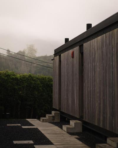 a wooden building with a red object on it at Landescape Furnas in Furnas