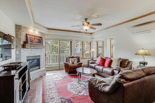 a living room with a couch and a fireplace at St. James Place in Beaver Creek