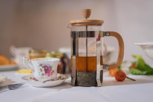 a coffee maker sitting on a table next to a cup at Agriturismo Maso Giomo in Brentonico