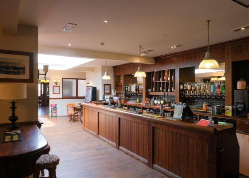 a bar in a restaurant with a counter and chairs at Cockerham Sands in Cockerham