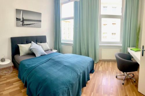 a bedroom with a bed and a chair and windows at Familienapartment in Wien in Vienna