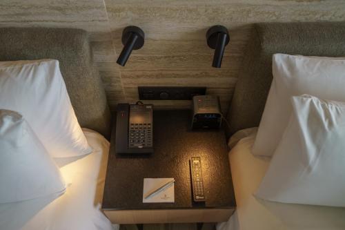 a hotel room with two beds and a phone and a night stand at Renaissance Cancun Resort & Marina in Cancún