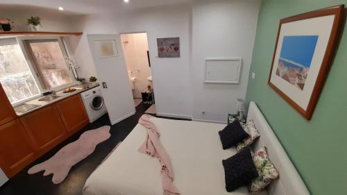 a bathroom with a bath tub and a washing machine at Lisbon apartment in Lisbon