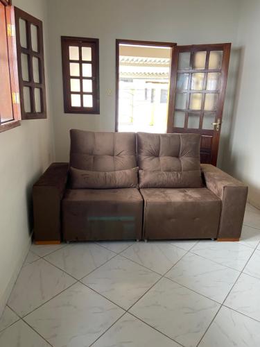 a brown leather couch in a living room at Casa agradável no centro in Bananeiras