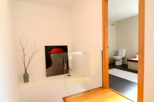a mirror in a bathroom with a painting on the wall at Ponent in L'Escala