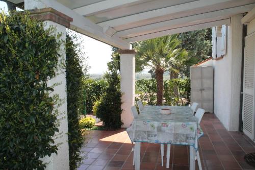 a patio with a table and chairs on a house at Casa Bianca Stella in Numana