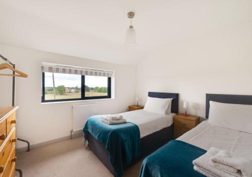a bedroom with two beds and a window at West View in Middleton