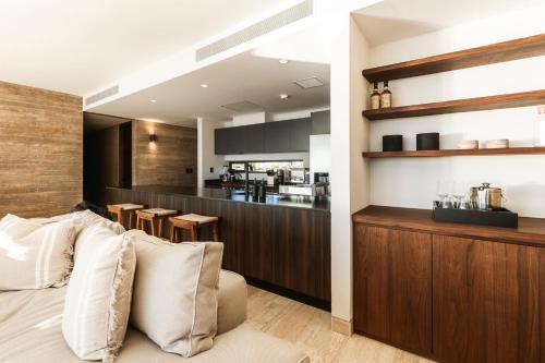 a living room with a couch and a kitchen at Private Hot Tub - Ocean View - GYM - Free Parking in San José del Cabo